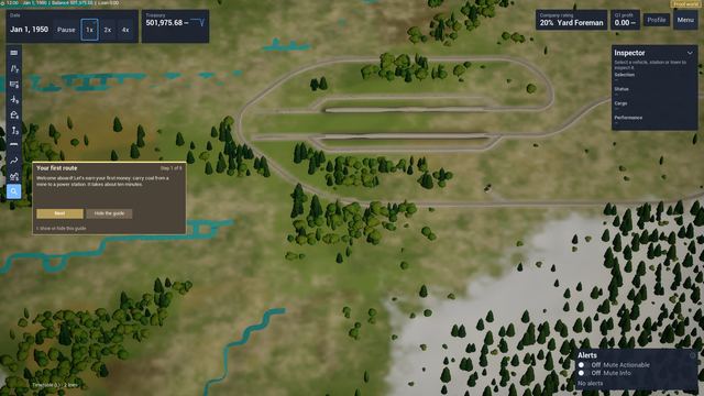 Top-down view of looped railway tracks in a forested landscape with the first-route welcome panel.